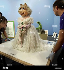 FILE - In this June 30, 2011, file photo, art handlers Jo Nigoghossia, left, and David Colosi, wheel in the muppet character Miss Piggy for the upcoming "Jim Henson's Fantastic World" exhibit, at the Museum of the Moving Image in the Queens borough of New York. The exhibit organized by the Jim Henson Legacy and The Smithsonian, to open July 16, explores the creative process of Henson through more than 120 artifacts, including drawings, animations, props and video material. (AP Photo/Richard Drew