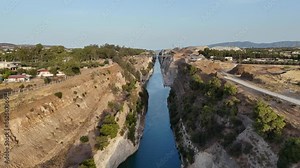 Corinth Canal, Greece. The Corinth Canal is a sluiceless shipping canal in Greece, connecting the Saronic Gulf of the Aegean and the Gulf of Corinth of the Ionian Sea, Aerial View