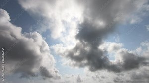Amazing timelapse video of fast moving dense clouds, appearing and disappearing in ever changing pattern with clear blue sky and bright big sun in background. Concept of oncoming of rains, weather etc Stock Video