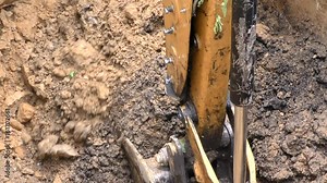 Bucket of the Tractor digs the ground. Construction machinery equipped with a bucket. The development of soils (rocks, minerals) and loading of bulk materials and piles. Working a production machine. Stock Video