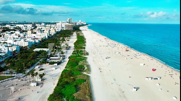 South Pointe Beach in South Beach Miami FL drone view flying right over the sand with views of the Atlantic Ocean.