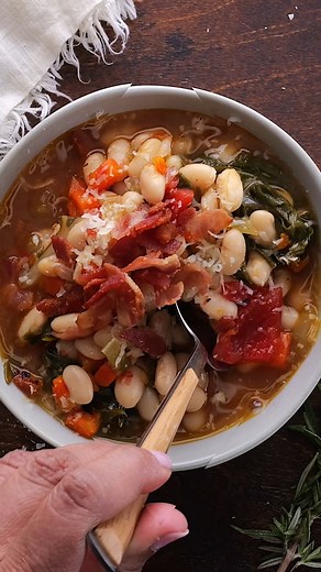 White Bean Soup is a hearty Italian style white bean soup featuring cannellini beans, vegetables, bacon, swiss chard, and Parmesan cheese. There is a nice combination of flavors and textures and the beans are creamy, flavorful, and soft, perfect for a comforting dish. #souprecipe #souprecipes #soupoftheday #beansoup #whitebeansoup #comfortfood | Will Cook For Smiles