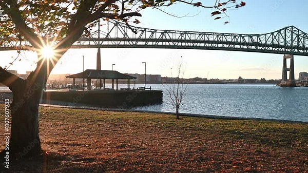 Boston in Massachusetts, USA showcasing the iconic architecture of the Tobin Bridge spanning over the Mystic river on a sunny sunrise.