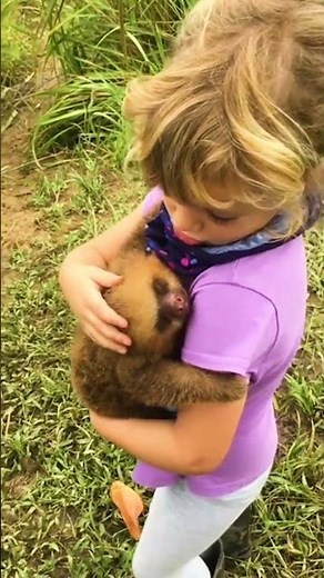 Toddler Cuddles Baby Sloth