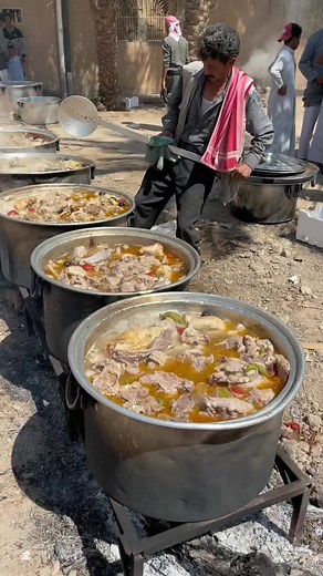 Outdoor Stew Cooking in Large Metal Pots