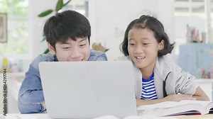 Young boys are using computers to teach and explain homework. To friends with facial expressions and happy gestures, Dolly shot 60fps.