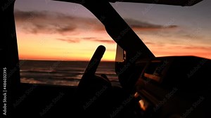 Road Trip in a Recreational Vehicle. Class C Overhead Bunk Motorhome RV Beach Sunset Camping Concept. Camper Van Front Close Up. Warm Colors. Rving Theme.