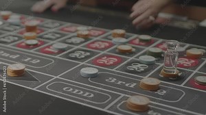 Slow motion footage of a croupier hand throwing dices on dealing craps table in a casino club
