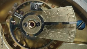 Internal vintage clockwork mechanism macro. Rotating gold gears, metal gearing, tootheds wheels. Disassembled watch with screws, cogwheels and winding spring. Open working clockwork. Rack focus.