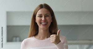 Head shot portrait happy woman look at camera show thumbs up, give positive feedback, recommends quality domestic cleaning services, having perfect smile advertise professional dental clinic concept