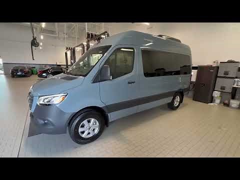 Show me a 12-seater Mercedes Sprinter Van, seating, legroom, cargo space, features, tall roof, 2023