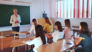 Female speaker giving lesson for university students in lecture hall