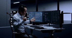 clip-1099738403-side-view-asian-male-programmer-celebrating-succeed