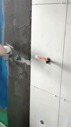 Applying adhesive mortar for precise ceramic wall tile installation