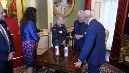 King and Queen light Holocaust memorial candle