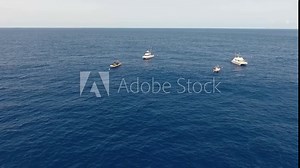 Making a circle with a drone around 4 boats that are anchored in place for diving at the Princess Alice Bank