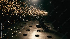 Slow motion: laser cutting, working with a metal workpiece with sparks in a factory. Metalworking, machining, industry, equipment, technology, production concept