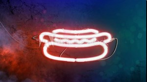 Neon hot dog sign illuminated dark marble wall, looped switch
