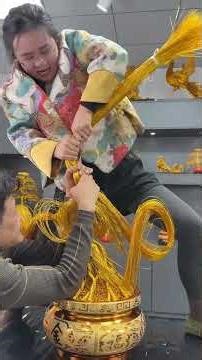 A craftsman turns a piece of iron wire into a work of art.