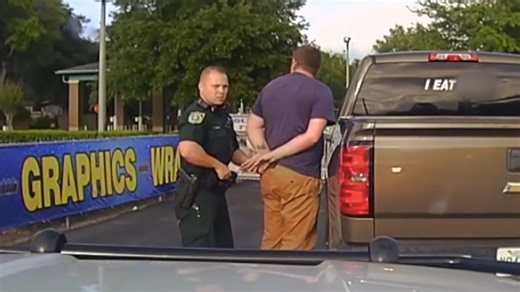 A man is arrested for having an inappropriate bumper sticker on his car in this scene from My Strange Arrest. | A&E