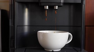 Download Making coffee by coffee machine into cup for free