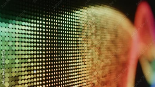 Abstract LED Screen Display - This close-up shot captures the vibrant texture and depth of an LED screen displaying a spectrum of warm colors, ranging from gold to red.