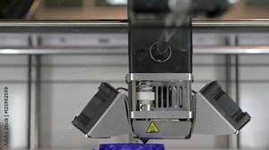 Front close-up view of 3d printer in process. It makes object with blue plastic. In ECC Sokolniki, Moscow at exhibition of 3D Expo