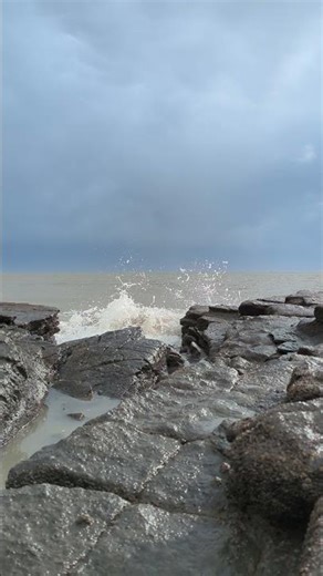 Powerful Wave Crash on a Moody Coast 🌊