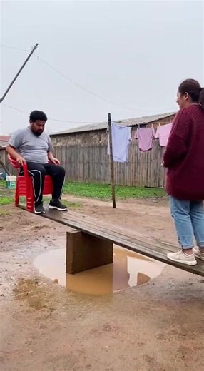She sent him flying! 🚀🤣 The ultimate Mud Pit Seesaw Prank. Wait for the landing... 💦 This backyard challenge definitely didn't go as planned for him. The moment that red chair goes airborne is pure chaos! #Prank #FunnyVideo #SeesawPrank #EpicFail #MudPit #BackyardFun #CouplePrank #ViralReels #FunnyFails #GravityCheck | Family Kitchen Secrets