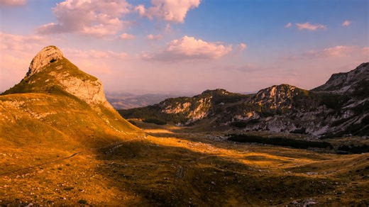 Evening light creating depth across hills and distant mountains