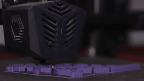 clip-3973780693-closeup-d-printer-extruder-printing-purple-filament