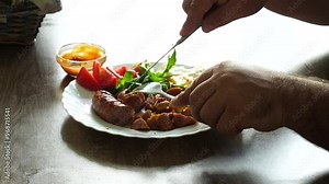 Man eats english breakfast at home