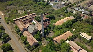 Aerial Kekaha Waimea Kauai Hawaii abandoned sugar mill circle. Old derelict built 1835. Rusty building and equipment. Garden Isle. Economy is now tourism based.