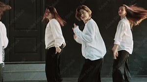 Beautiful young women with perfect body dancing indoors. Dancing talented women. Elegant females dancing modern dance. Modern professional dances. Group of stylish young people dancing. 4K, UHD