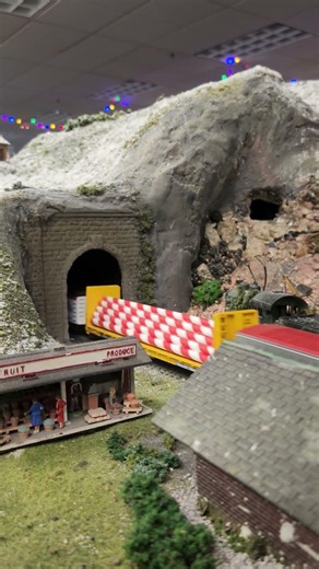 HO scale christmas freight train passing through old mining town