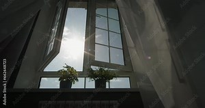 Sunshine streaming through open window. Cinematic video, freedom, take deep breath, expanding boundaries. Oasis of relaxation, sunlit apartment. Wind blows curtain in house, hotel, apartment