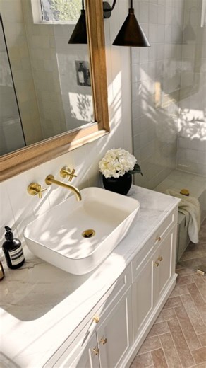 Before & after magic ✨ A rustic farmhouse dream brought to life with our Thirroul Bone Matte Subway Tile on the floor and our Albert Park Square Matte Vanilla Tile on the walls. Beautifully finished with our Brushed Brass tapware for the perfect warm glow. @danielle_collis | Yabby