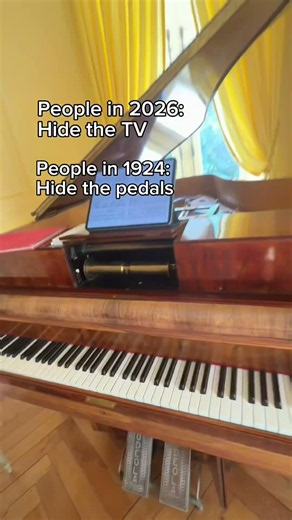 This 1924 Erard has a pneumatic reproducing system operated by pedals hidden inside a cabinet.