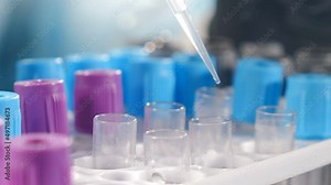 Scientist analyzes and extracts DNA or molecules in test tubes with pipette. Laboratory assistant using lab equipment. Pipette with transparent liquid dropping into glass test tube in laboratory Stock Video