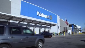 Walmart boosts sales outlook as shares surge to record high