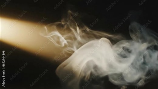 Smoke illuminated by a beam of light against a dark background