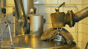 Growing distillery for the production of plum brandy by firing in a gas boiler, alembic pot still during process of distillation flow fresh plum brandy, bottles plum liquor slivovitz traditional czech