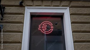 Red EURO logo on a reflective window of a modern financial blockchain office