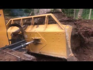 Still clearing and burning Deere 700K pushes out biggest stumps ever!