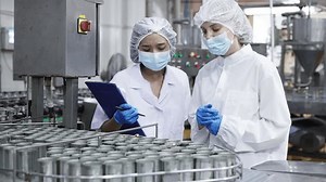 Quality control inspectors in a food processing plant