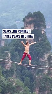 A breathtaking high-altitude slackline competition began Monday in Zhangjiajie City, Hunan Province, bringing together more than 20 top slackliners from around the globe to compete for the championship. Now in its eighth year, the event has been held annually since 2018 and has become a signature attraction of Zhangjiajie National Forest Park. Athletes from 10 countries—including China, France, Germany, and the United States—dazzled spectators with gravity-defying stunts as they balanced on a sl