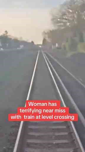Woman Has Terrifying Near Miss with Train at Level Crossing