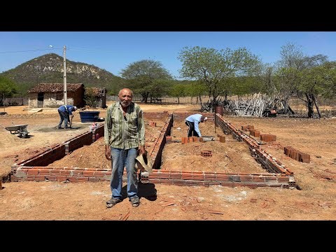 Mr. Luiz, 80 years old, can't hide his happiness at seeing his house finally becoming a reality.
