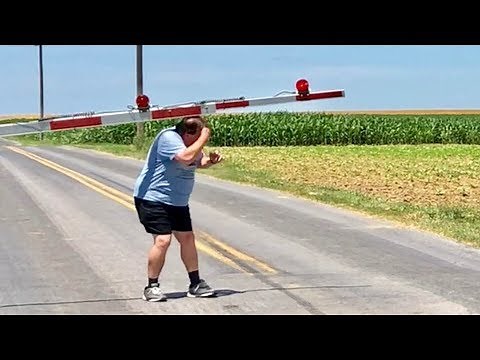 Man Hit On Head By Railroad Crossing Gate! Steam Train Coming! What A Train Wreck! So To Speak