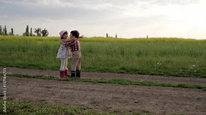 cute children hugging each other, Meeting friends, running around field road, slow motion, boy and girl are happy meet, beautiful smiling kid playing outdoors, little brother and sister laughing